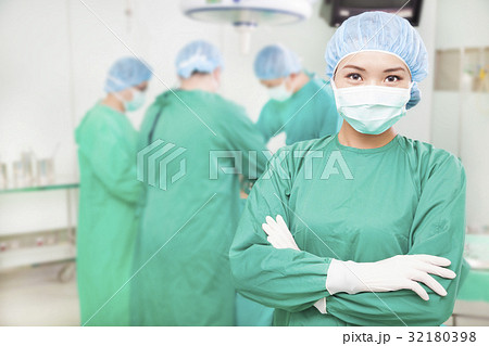 female surgeons  crossed hands with  teams 32180398