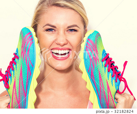 Happy young woman holding shoes 32182824