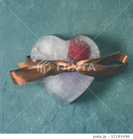 Heart shaped ice cubes with frozen cherry 32193496