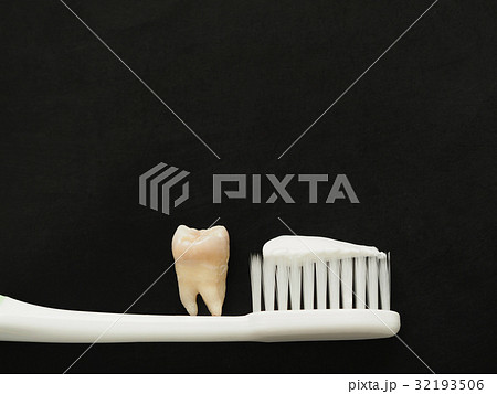Real tooth on white toothbrush with toothpaste 32193506