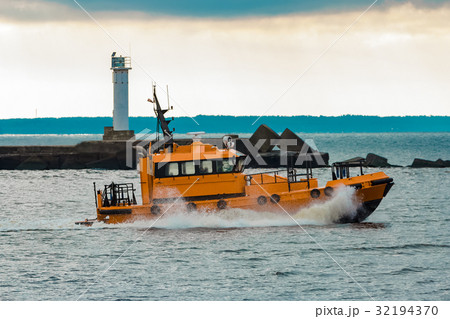 Orange pilot ship moving at speed 32194370