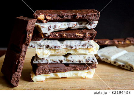 chocolate bar stack on wooden background. 32194438