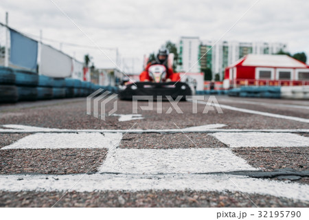 Karting racer on finish line, go kart competition Karting racer on finish line, go kart competition 32195790