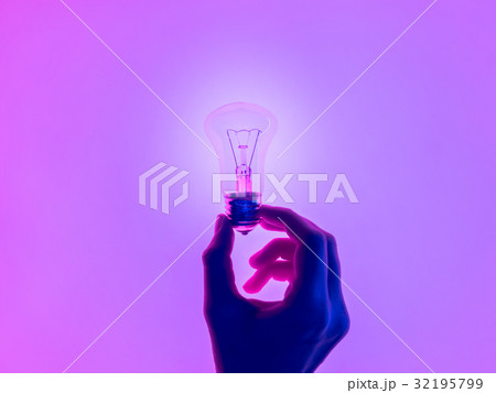 Female hand and holding luminous light bulb. Female hand and holding luminous light bulb. 32195799