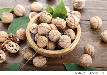 Walnuts in a wooden plate 32201334