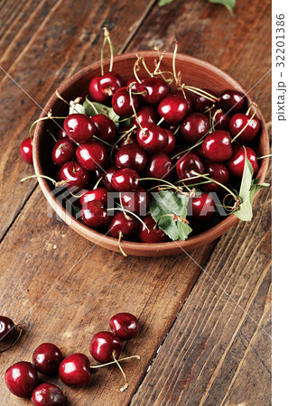 Juicy ripe cherries on a wooden table 32201386