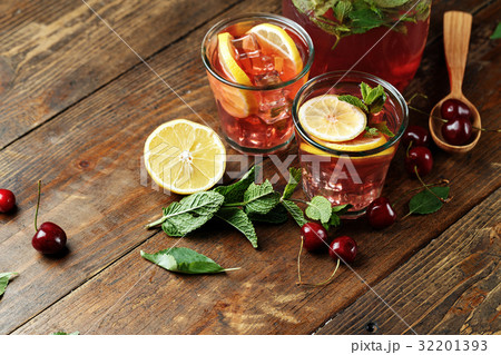 Refreshing drink with cherries and lemon 32201393
