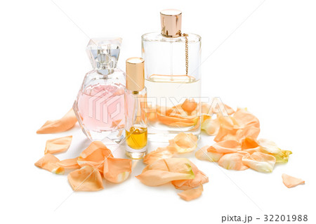 Perfume bottles with flower petals on light 32201988