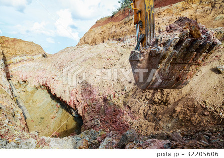 Excavator digging a trench for the pipeline.  32205606