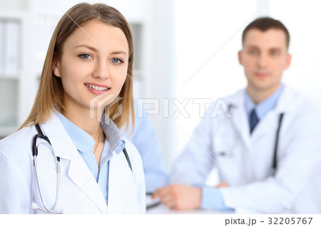 Young beautiful female doctor smiling  on th 32205767