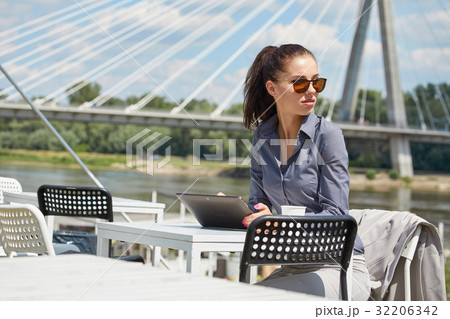 woman working with laptop/internet/online shopping at outdoor pa woman working with laptop/internet/online shopping at outdoor pa 32206342