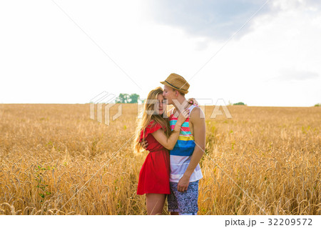 Happy young couple enjoying in the wheat field 32209572