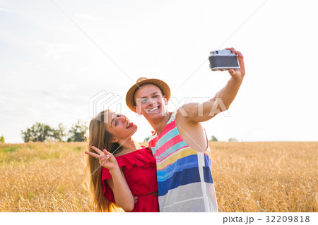 Young happy couple taking a selfie in the field 32209818