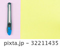 cutter knife  placed on a pastel paper 32211435