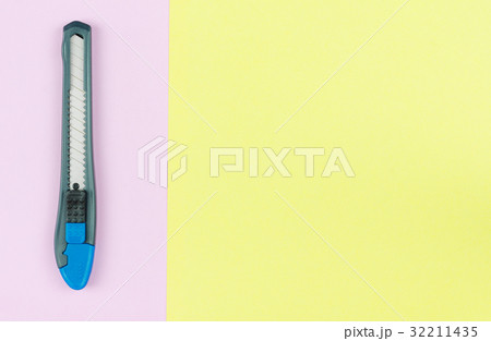 cutter knife placed on a pastel paper cutter knife placed on a pastel paper 32211435