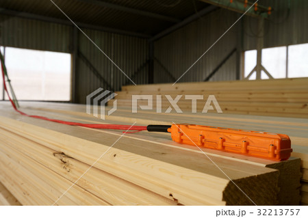 Remote control for crane is on wooden bar Remote control for crane is on wooden bar 32213757