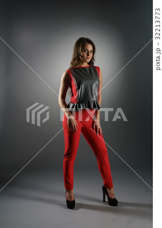 Smart brunette in slinky pants and top in studio 32213773