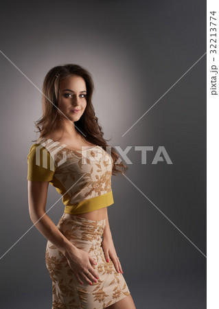 Pretty girl in yellow printed top and mini 32213774