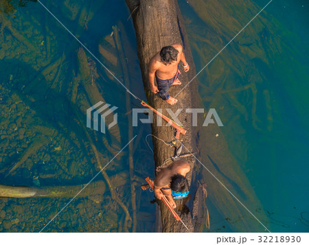 fisherman hunt fish by gun in Kwai river fisherman hunt fish by gun in Kwai river 32218930