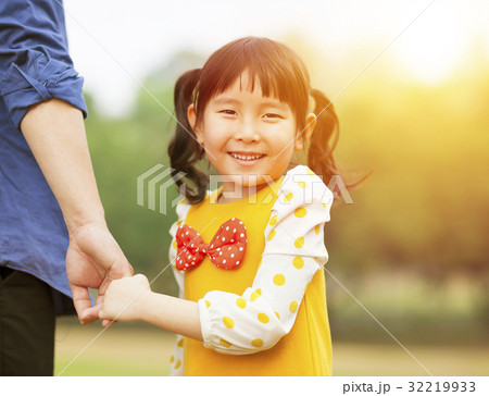 girl hold father hand  in the park with sunlight 32219933