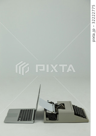Laptop and typewriter on white background 32222775