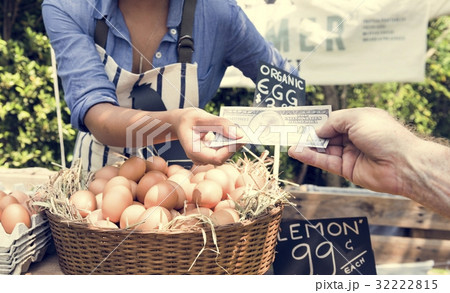 Woman Selling Fresh Chicken Eggs at Local Farmer Market Woman Selling Fresh Chicken Eggs at Local Farmer Market 32222815