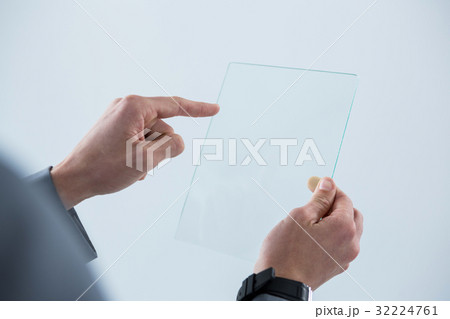 Businessman touching an glass sheet Businessman touching an glass sheet 32224761
