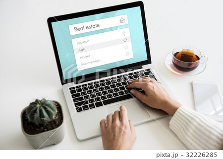 People using digital laptop about real estate word 32226285
