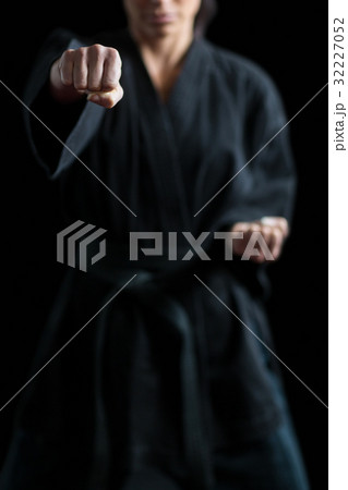 Female karate player performing karate stance Female karate player performing karate stance 32227052
