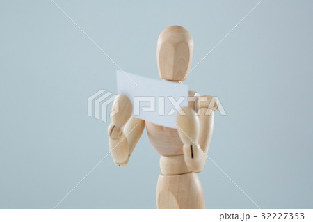 Wooden figurine holding blank placard 32227353