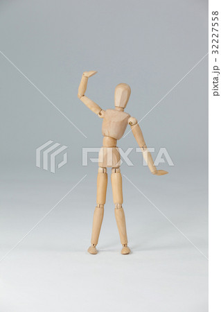 Wooden figurine standing with hand raised Wooden figurine standing with hand raised 32227558