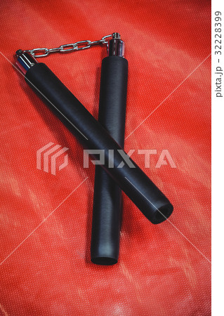 Nunchaku on red background 32228399
