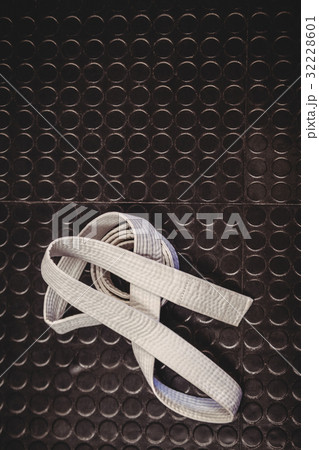 Karate white belt on metallic background 32228601