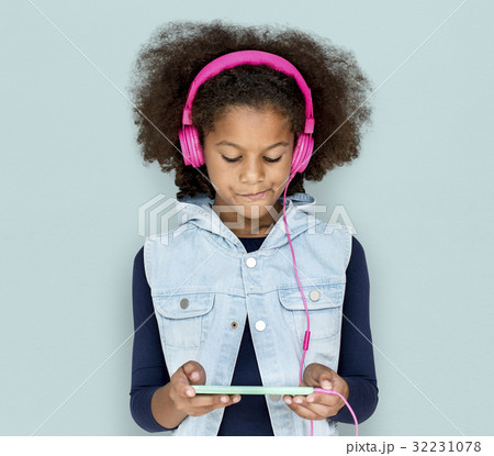 Little Girl Headphones Using Phone 32231078