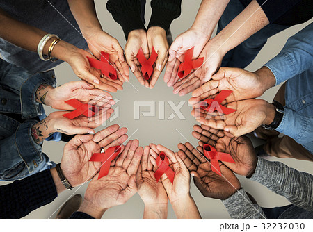 Group of hands holding red ribbon stop drugs and HIV/AIDS awareness Group of hands holding red ribbon stop drugs and HIV/AIDS awareness 32232030