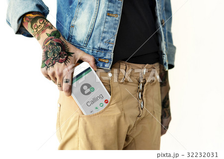 Hand holding network graphic overlay digital device in trouser pocket 32232031