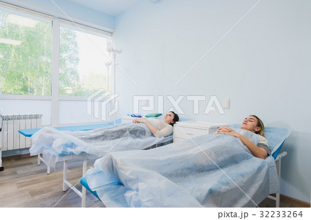 Female patient sleeping in medical bed at the Female patient sleeping in medical bed at the 32233264