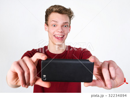 Young man taking selfie Young man taking selfie 32234894