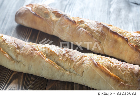 Two baguettes on the wooden background Two baguettes on the wooden background 32235632
