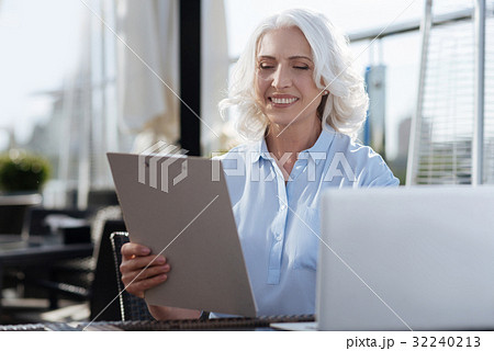 Pretty woman holding folder with documents Pretty woman holding folder with documents 32240213