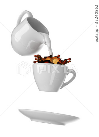 Milk being poured into small cup of coffee Milk being poured into small cup of coffee 32240862