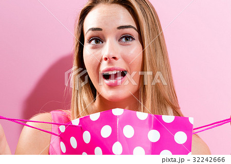 Young woman holding a shopping bag Young woman holding a shopping bag 32242666
