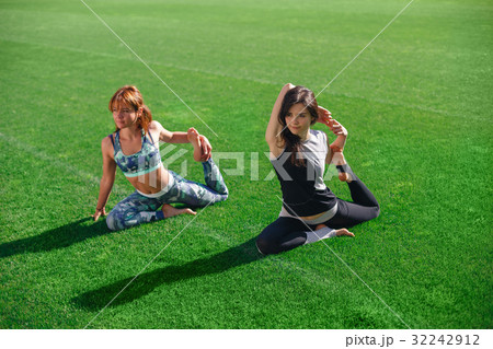 Two young yoga female doing yogatic exericise at 32242912