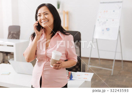 Joyful pregnant woman talking on smart phone 32243593