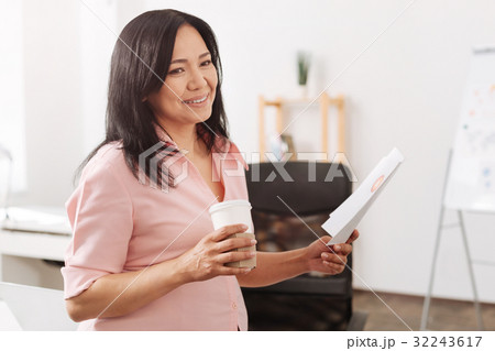 Smiling pregnant woman standing in the office Smiling pregnant woman standing in the office 32243617