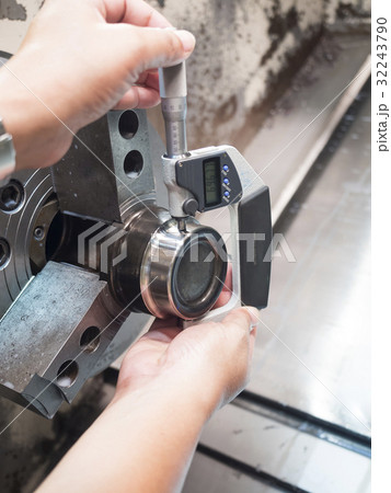operator machining mold part by CNC machine 32243790