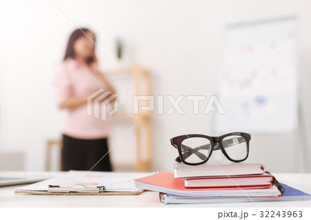 Selective focus of glasses with pregnant woman 32243963