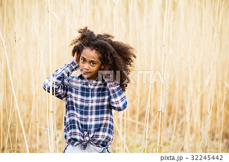 African american girl in checked shirt outdoors in 32245442