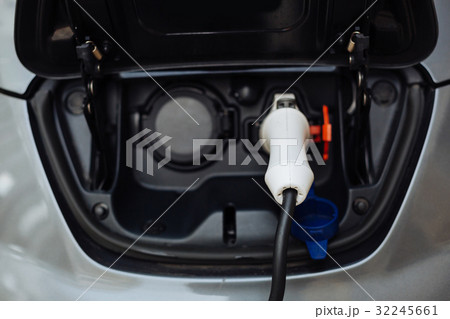 White electrical nozzle charging an e-car 32245661