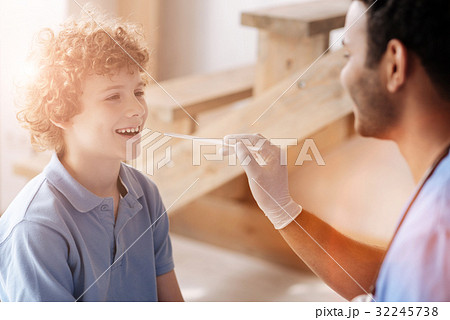 Positive delighted medical worker doing throat Positive delighted medical worker doing throat 32245738